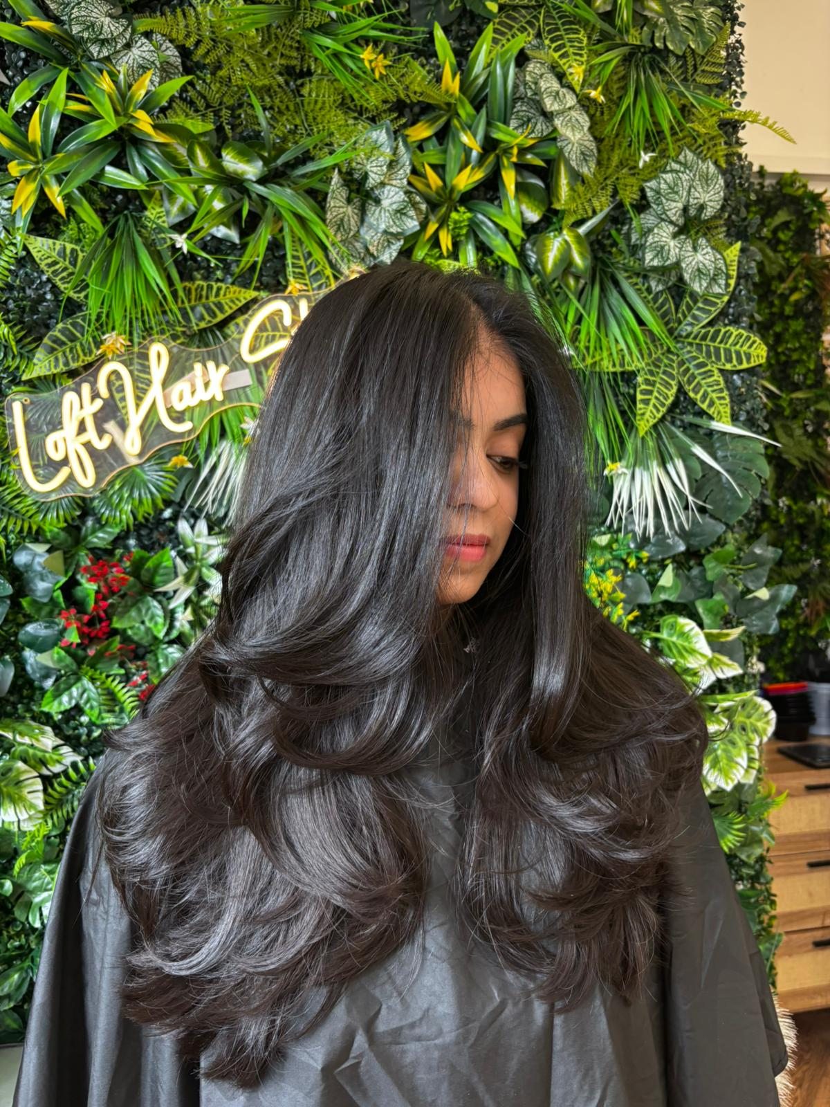 Glossy black hair with voluminous layers